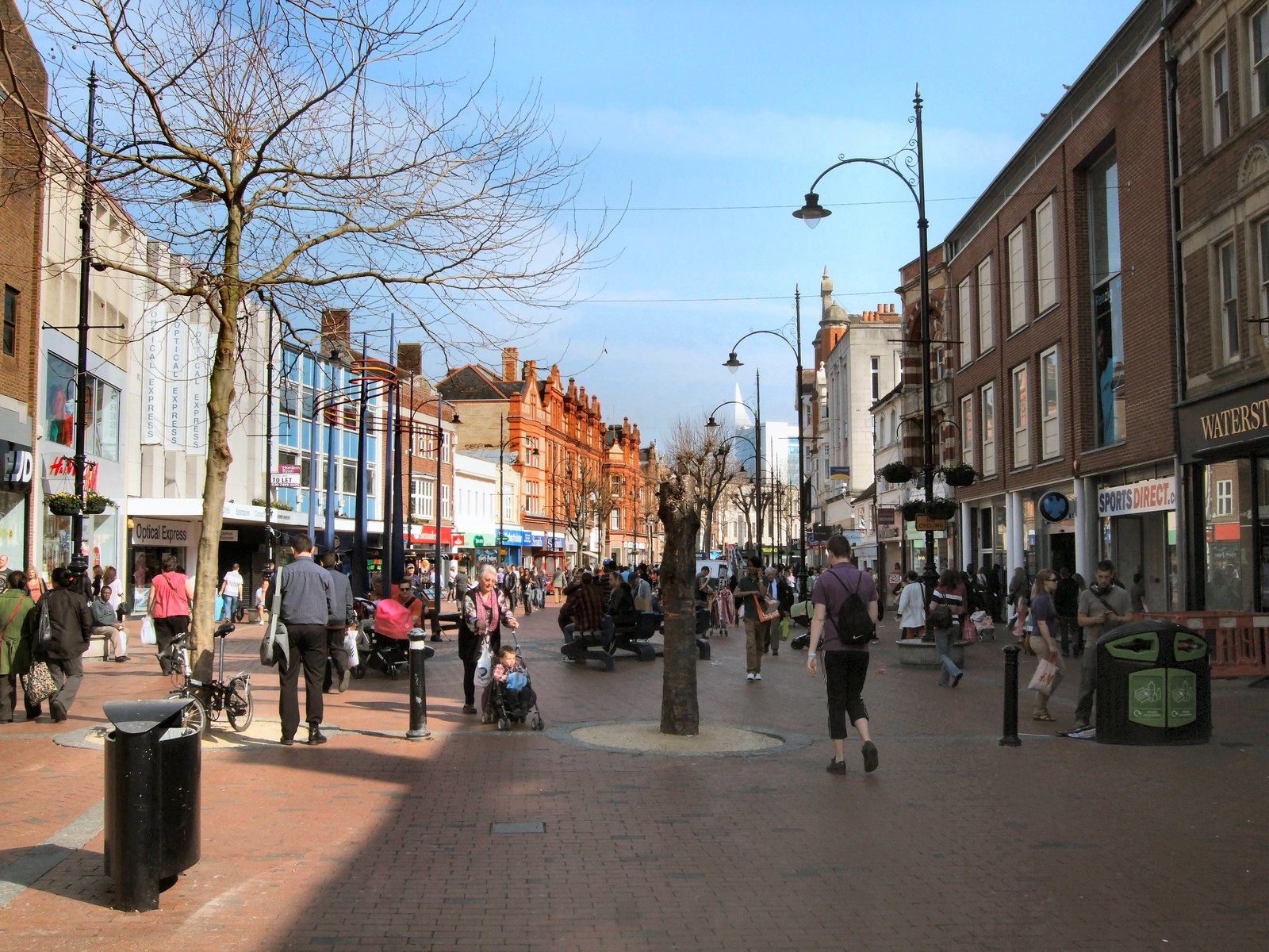 A busy pedestrian street scene shows a typical environment for large events and festivals.